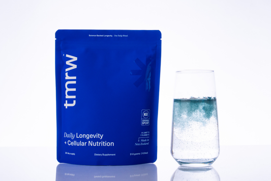 Tmrw longevity supplement pouch with glass of water.